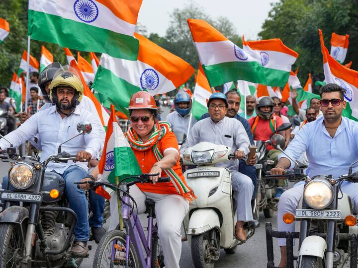 Union Minister of State for Culture Meenakshi Lekhi rides a bicycle with other participants during the Har Ghar Tiranga Bike Rally. (Photo: PTI)