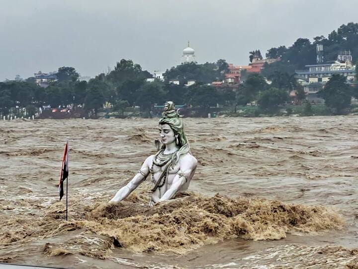 An idol of Lord Shiva partially submerged in swollen Ganga river after monsoon rains, at Parmarth Niketan Ghat in Rishikesh. (Photo: PTI)