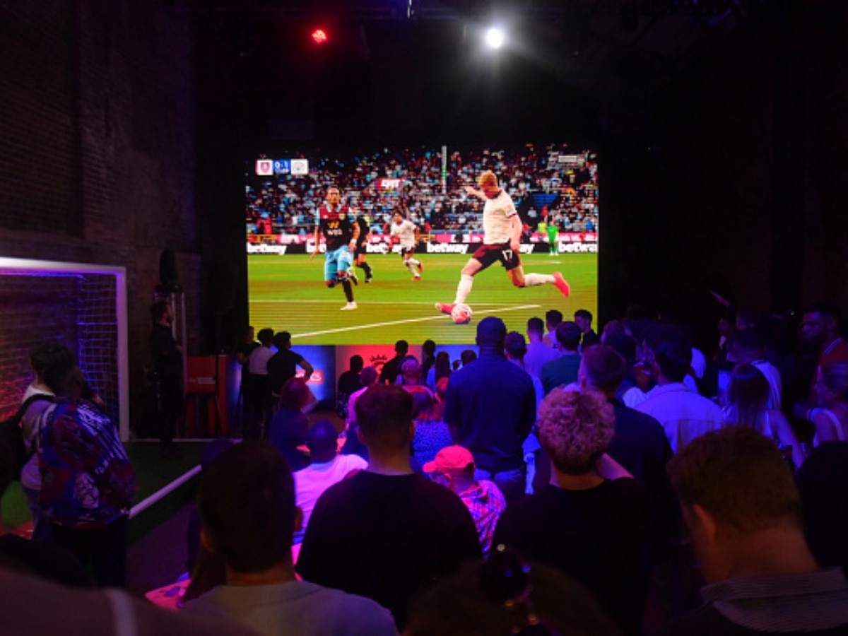 Side View Of Three Men Sitting On Couch Watching Football Match On  Television Stock Photo, Picture and Royalty Free Image. Image 36498081.