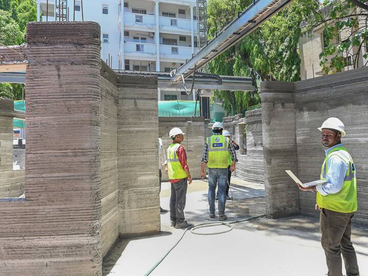 A robotic printer deposited the concrete layer-by-layer. The special grade concrete hardens quickly and is used to ensure bonding between the layers to print the structure. (Source: PTI)