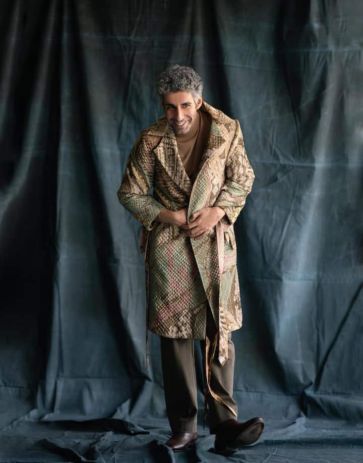 In yet another striking jacket choice, Jim Sarbh dons a long coat in earthy tones, paired impeccably with a brown turtleneck. This ensemble radiates warmth and sophistication, while looking extremely suave.  The long coat becomes more than just an outfit, it's a statement of poise and understated elegance.