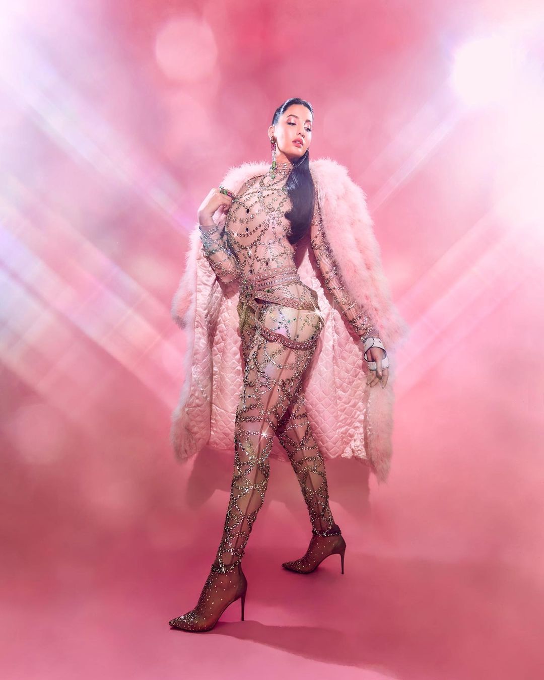 Nora Fatehi looks enchanting in baby pink blingy bodysuit with matching fur  coat, and statement accessories