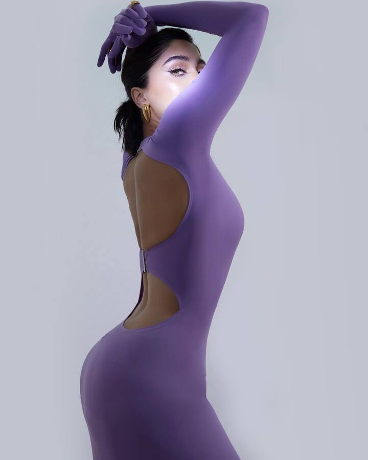 The back of her long-sleeved gown had a cutout element.