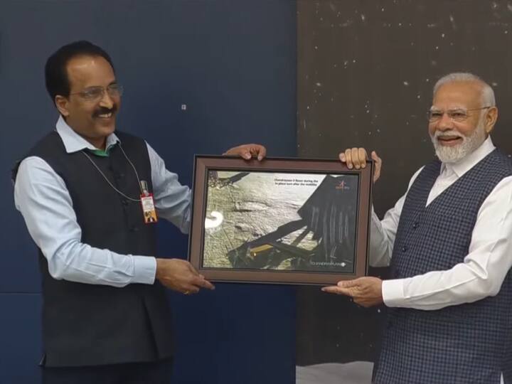 ISRO chairman S Somnath presents Prime Minister Narendra Modi with one of the first images taken by the Moon lander's camera as it was nearing the lunar surface. (ANI)