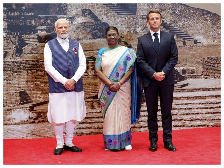 President Droupadi Murmu and Prime Minister Narendra Modi welcome President of France Emmanuel Macron upon his arrival at the Bharat Mandapam for the grand G20 dinner. (Image: PTI)