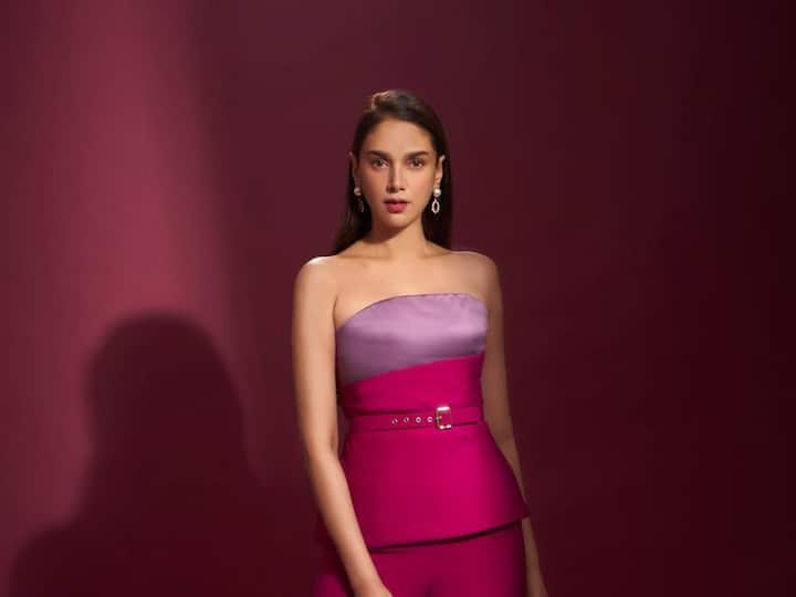 Aditi Rao Hydari looked lovely in an off-the-shoulder pink top with a violet pattern at the torso and a pink belt.