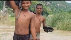 In Pics: भविष्य से खिलवाड़! हाथ में चप्पल, कंधों पर बैग, जान जोखिम में डालकर नदी पार कर स्कूल जाते हैं बच्चे