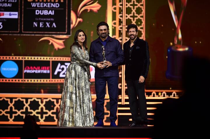 R Madhavan looked dapper on the red carpet with a black jacket, trousers, and blue shoes.