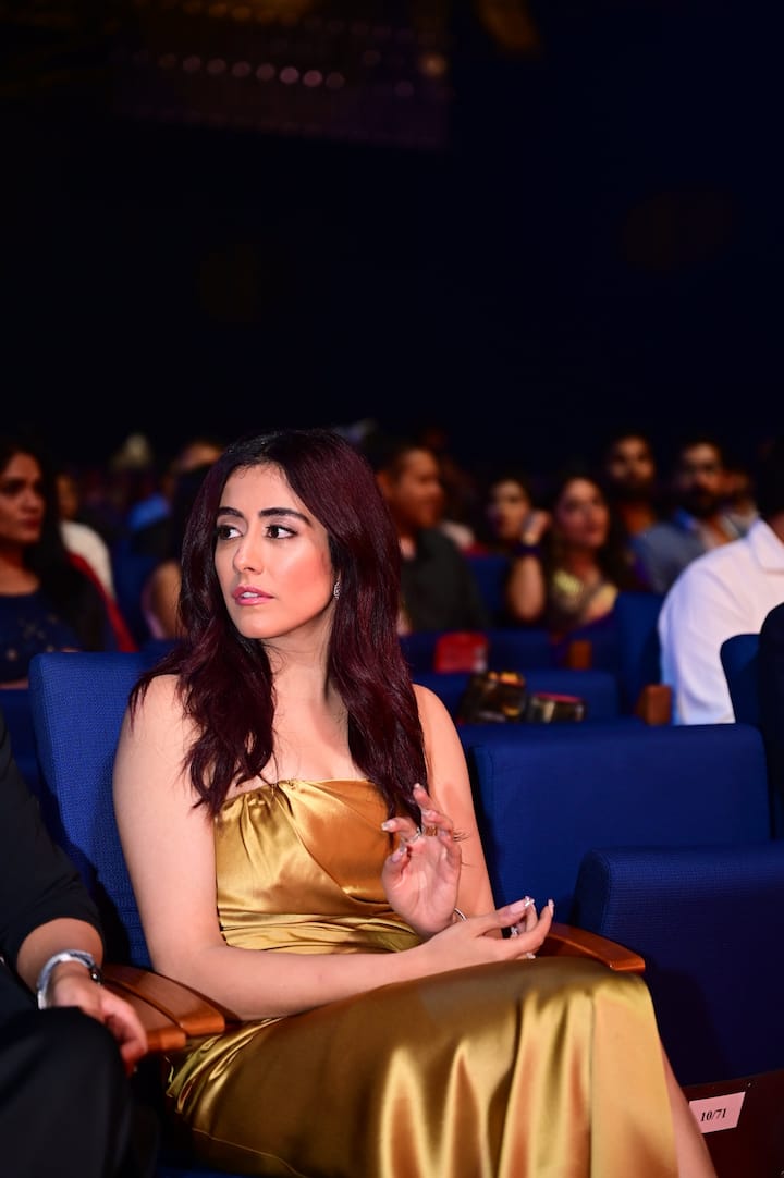 On the red carpet, Jonita Gandhi made her entrance in a chic golden gown with an off-the-shoulder thigh-high slit.