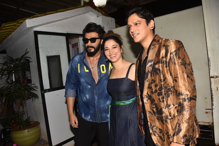 Arjun Kapoor turned up in a swagger look sporting a printed denim shirt and black jeans. He struck a pose with Vijay and Tamannaah.