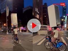 सिर पर बिना सपोर्ट के फ्रिज रखकर साइकिल चलाता नजर आया शख्स, VIDEO देखकर छूटे लोगों के पसीने