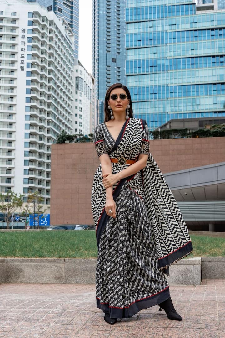The Indian actor, nominated for Best Lead Actress at the festival, made quite an impression with her unique fashion choice—a saree with a contemporary twist in her day 1 look of the festival. (Image Source: Instagram/ Karishma Tanna)