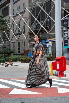 Karishma Tanna Oozes Elegance In A Black And White Saree On The Streets Of Busan