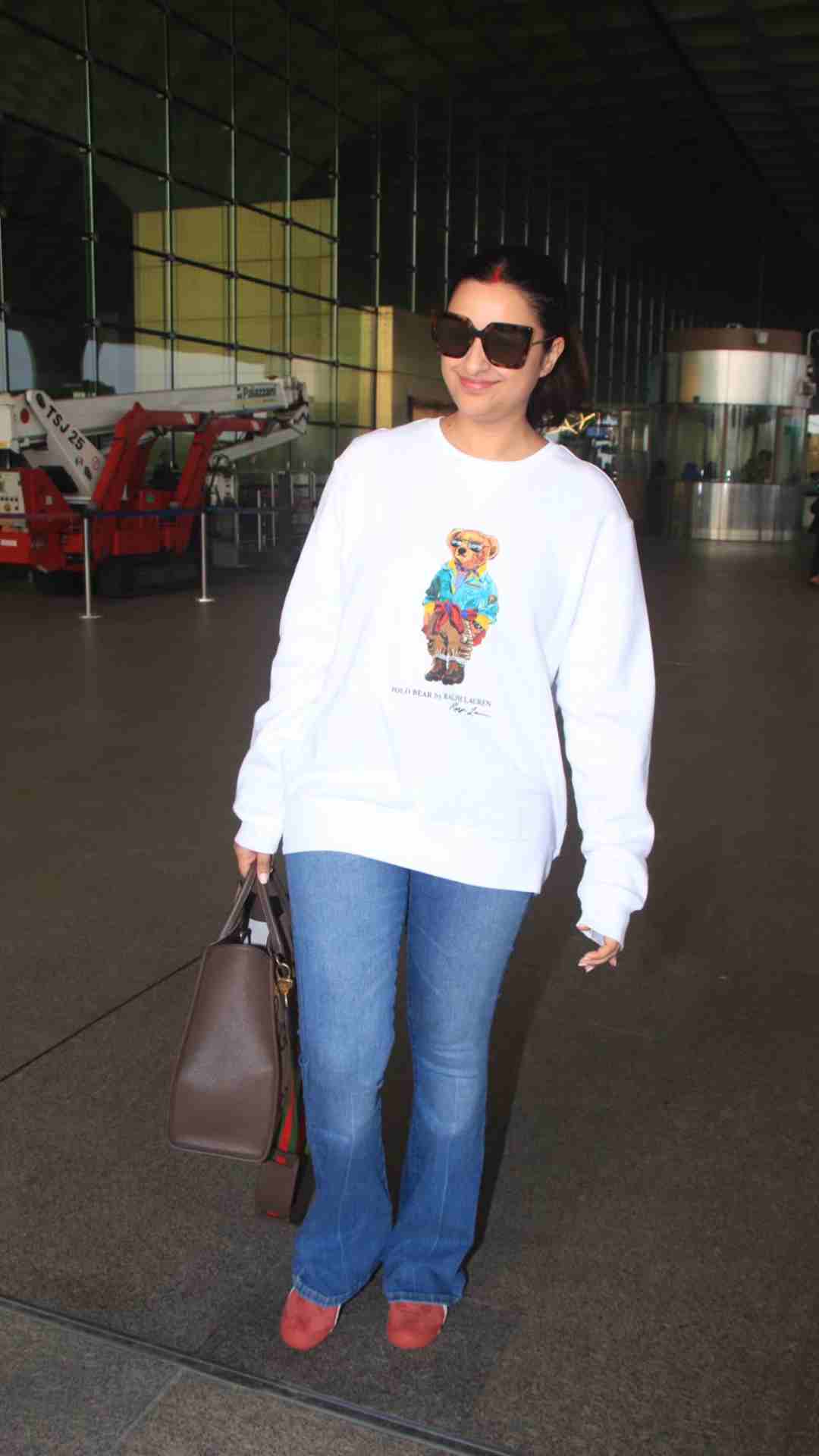 With a sweatsuit worn with a Louis Vuitton tote bag, Parineeti