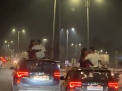 कपल ने चलती कार के रूफ पर खुलेआम किया किस, इंटरनेट पर भड़का लोगों का गुस्सा- Viral VIDEO