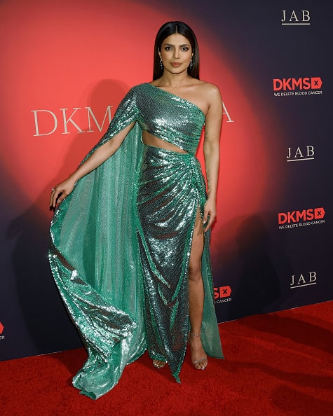 The one-shoulder gown had a sleeve appearing like a cape and cut-out detailing on midriff.