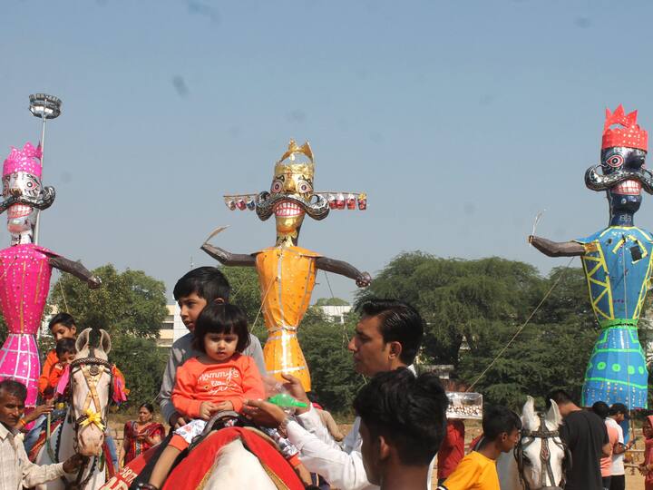 People visit the Dussehra ground as effigies of demon King Ravana, Kumbhkaran and Meghnad are installed for Vijayadashmi celebrations, in Faridabad. Image Source: PTI