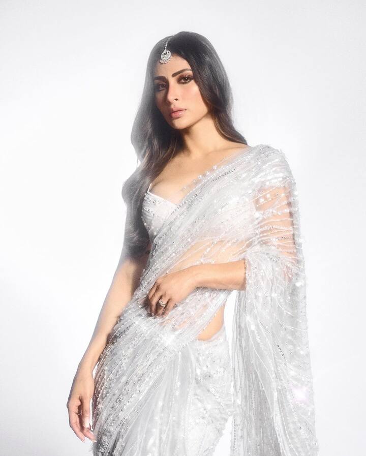 Mouni's ensemble was finished off with a silver mang tika and diamond rings.