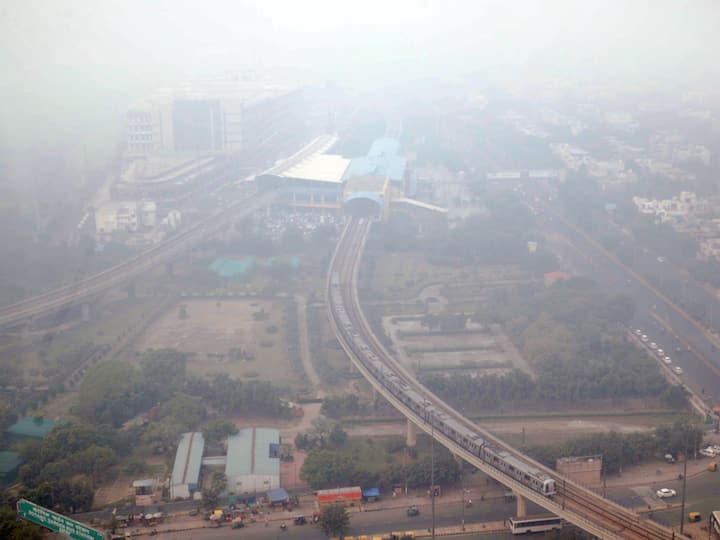 A metro train runs on its track amid smog, in Noida on Thursday. (Image Source: PTI)