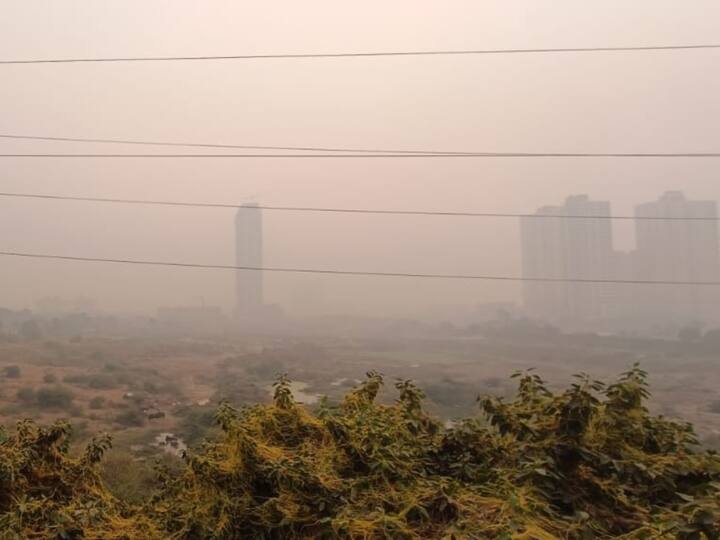 Buildings are shrouded in Smog in Noida during afternoon amid deteriorating Air Quality Index (AQI). The AQI level stands at 345 with prominent pollutant being PM 2.5, according to Central Pollution Control Board (CPCB) data. (Image Source: ABP Live)