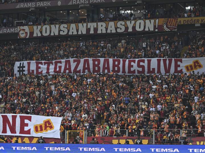 Palestinian supporters hold a banner that reads