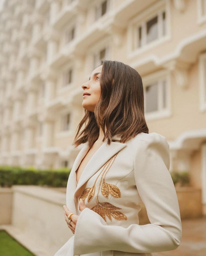 The pants have a flared hem, a loose silhouette, and a high-rise waist.