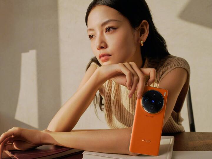 The handset in orange hue has a textured back made of vegan leather.