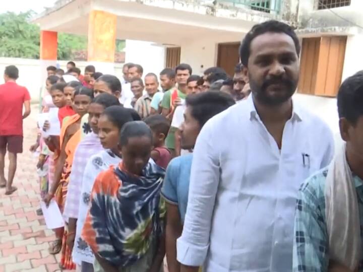 People stand in a queue outside a polling booth in the Sukma Assembly Constituency to cast their votes. (Source: ANI)