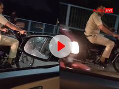 Watch: बिना हेलमेट के बाइक चला रहा था पुलिसकर्मी, कार में बैठी महिला ने पढ़ाया ट्रैफिक का पाठ, देखें VIDEO
