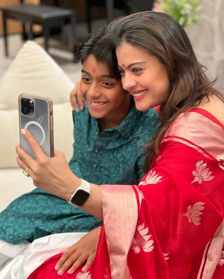 Kajol was seen wearing a red saree with silver lotus motifs on it. She kept her hair open, and completed the look with red bangles.