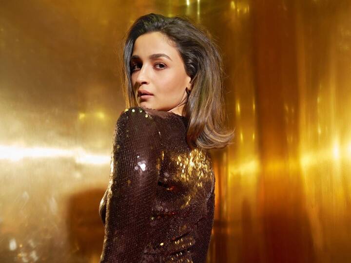 At the Koffee with Karan Season 8 couch, Alia Bhatt radiates glamor in a full-body sequined brown outfit.