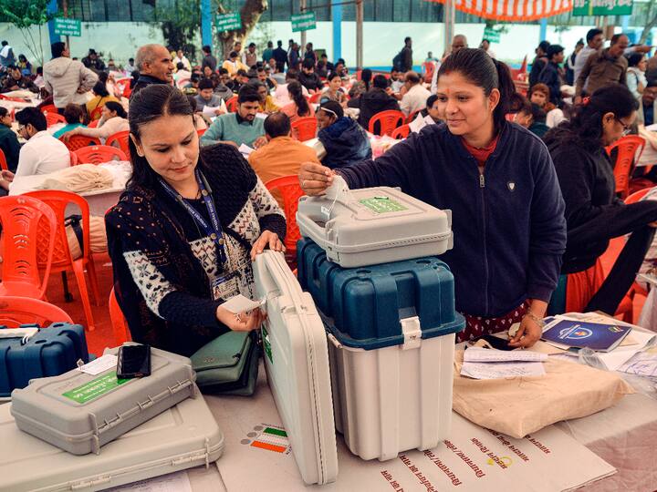Polling officials at a distribution centre pack EVMs ahead of election day in Jabalpur. (Source: PTI)