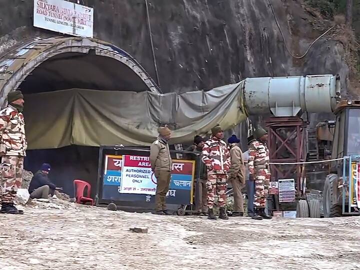 Security personnel outside the under-construction tunnel as various teams remain engaged in the work to rescue the trapped workers. (Source: PTI)