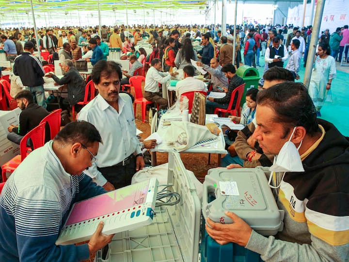Polling officials pack an EVM at a distribution centre of election material ahead of polling on Friday. (Source: PTI)