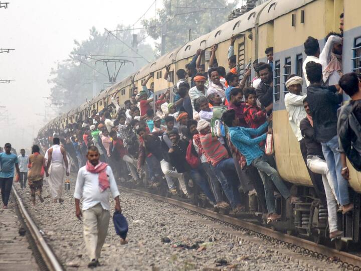 People travel by an over-crowded train to reach their hometowns ahead of the Chhath Puja festival, near Patna railway station. (Source: PTI)