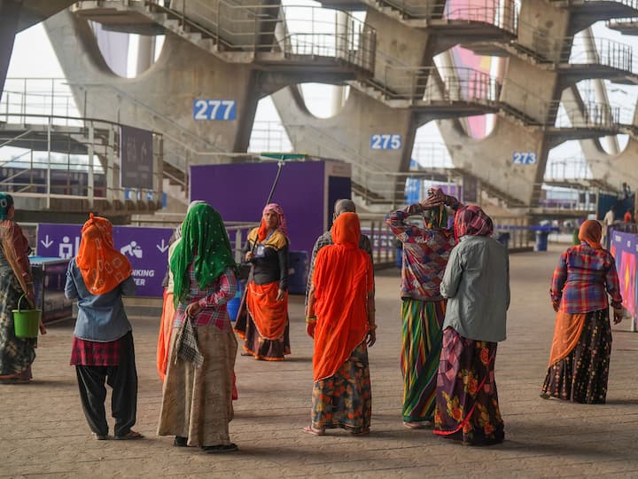 Workers clean up the Narendra Modi Stadium in Ahmedabad before the ICC Men’s Cricket World Cup 2023 final between India and Australia on Sunday. (Source: PTI)
