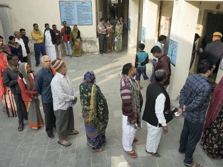 People queue up to cast their votes for the Rajasthan Assembly election in Pushkar on Saturday. (Source: PTI)