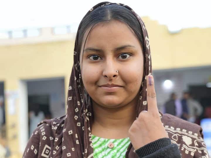 Muskan, a first-time-voter, shows her finger marked with indelible ink after casting her vote for the Rajasthan Assembly elections in Beawar district. (Source: PTI)