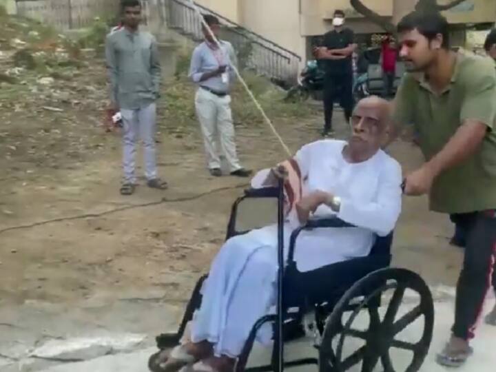 A man in a wheelchair being assisted as he makes his way to cast his vote during the Telangana Assembly Elections, in Jubilee Hills on Thursday. (Source: ANI)