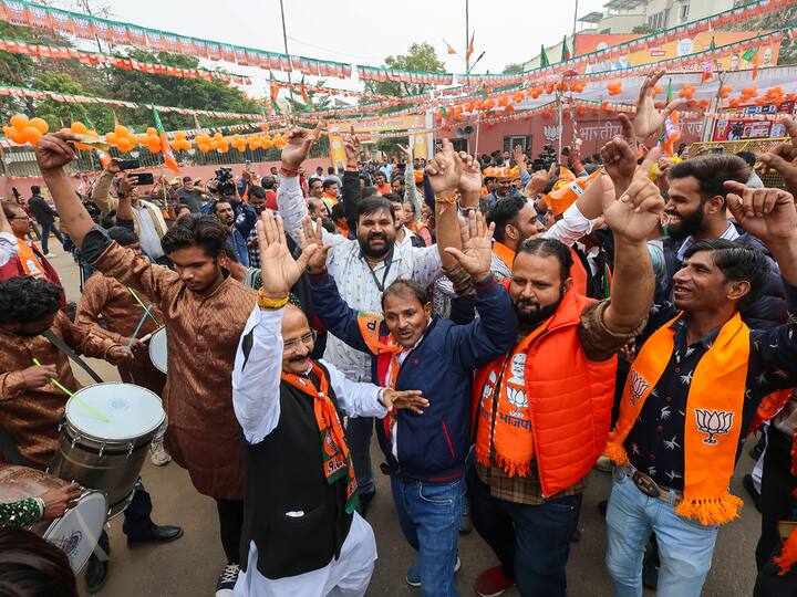 BJP workers and supporters celebrate outside the party headquarters during counting of votes for the Rajasthan Assembly elections, in Jaipur on Sunday. (Source: PTI)