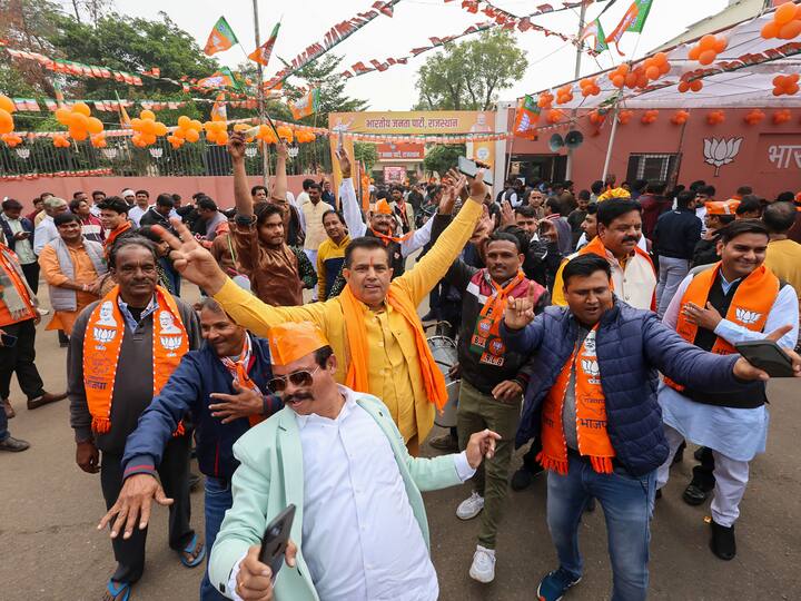 BJP workers and supporters dance in celebration outside the party headquarters in Jaipur. (Source: PTI)