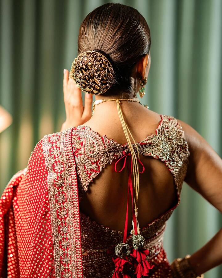 She had her hair styled into a sleek bun adorned by an intricate hair accessory.