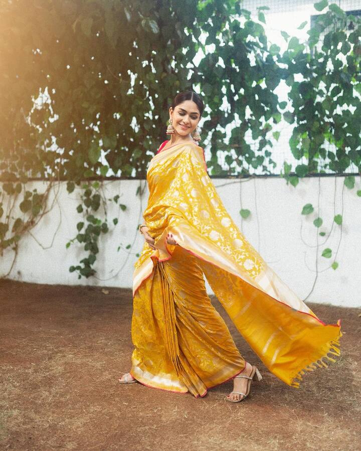 Mrunal Thakur embraces a yellow saree with an intricate floral print design covering the fabric. (Image: Instagram/@mrunalthakur)