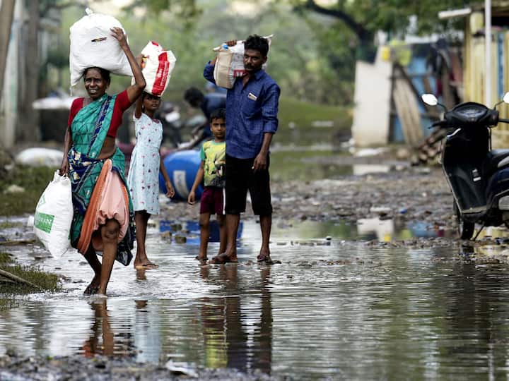 Locals retrieve their belongings in the Kamatchi Amman Nagar area that was flooded after heavy rainfall in Chennai. (Image Source: PTI)