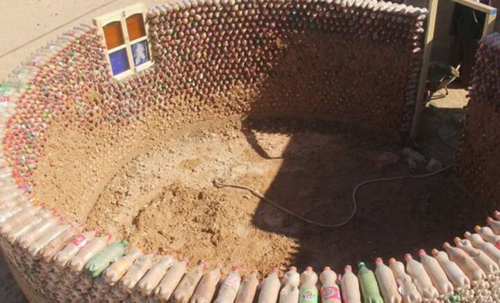 নাইজিরিয়ার উন্নয়ন এবং পুনর্নবীকরণ বিভাগের আধিকারিক ইয়াহায়া আহমেদ জানিয়েছেন, বালি ভর্তি প্লাস্টিকের বোতলের ক্ষমতা ইঁটের চেয়ে ২০ গুণ বেশি। বোতলে বালি ভরে তিন তলা বাড়িও তৈরি করা হচ্ছে বলে জানিয়েছেন তিনি।   ছবি: টাটেহ্ লেহবিব বারিকার ট্যুইটার হ্যান্ডল থেকে সংগৃহীত।