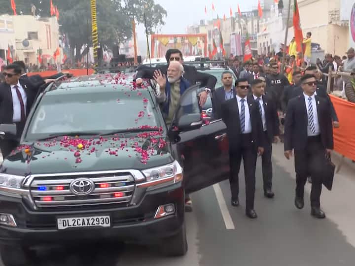 PM Modi waves at people from his car during his roadshow in Ayodhya in Uttar Pradesh. (Source: PTI)
