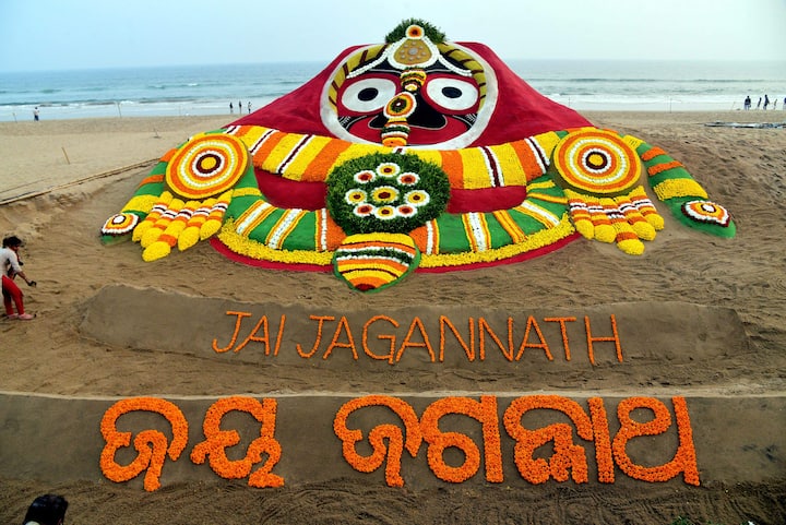 Sand artist Sudarsan Pattnaik creates a sand sculpture of Mahaprabhu Jagannath on new year eve, at Puri beach. (Image Source: PTI)
