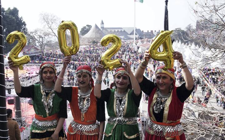 Girls in traditional Himachali attire hold balloons to form 2024 during New Year celebrations, in Shimla. (Image Source: PTI)