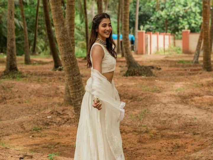 Pooja Hegde wore a white lehenga with dori embroidery to a wedding in Karnataka.