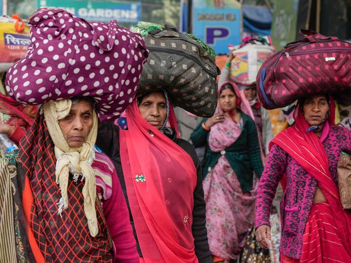 Gangasagar Mela pilgrims arrive at a transit camp on their way to Sagar Island ahead of 'Makar Sankranti' at Babughat in Kolkata on Thursday.
